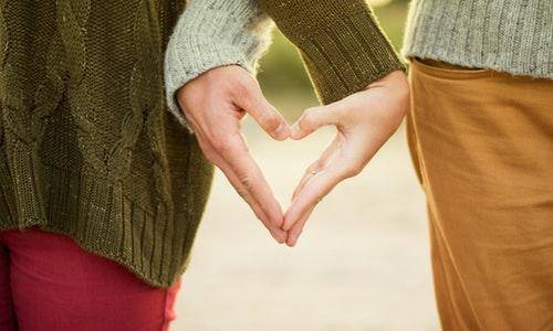 a pair of hands making a heart shape