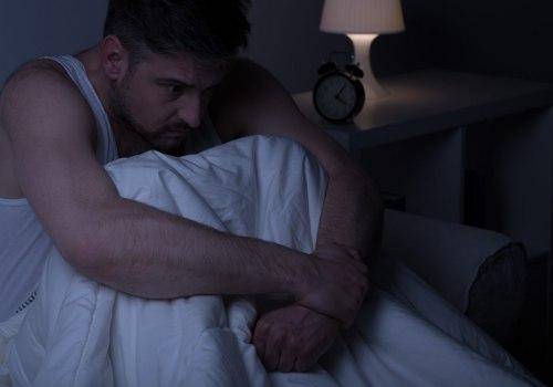 man thinking in his bed