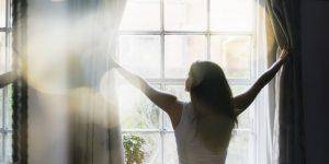 woman opening window