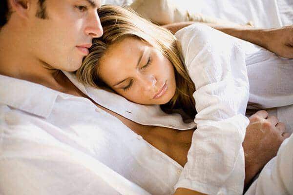 man and woman cuddling