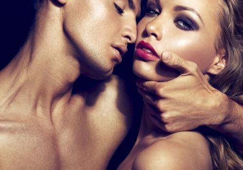 man kisses on girl's neck