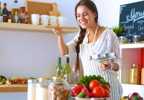 happy lady cooking in the kitchen