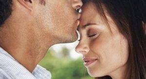 man kissing forehead