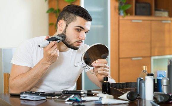 man trimming his beard
