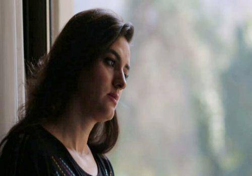 sad lady seeing outside window