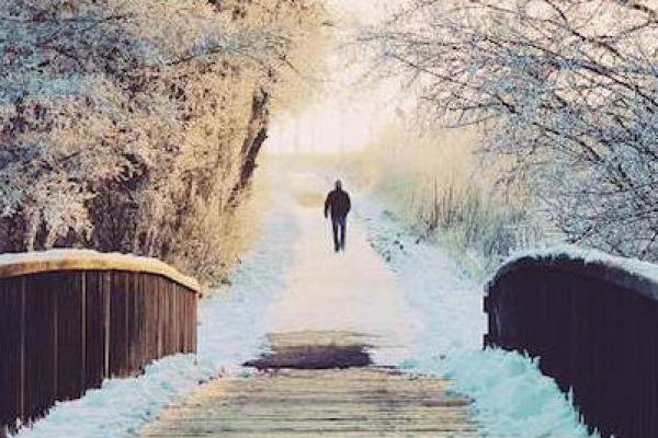 Man Walking Ahead of Bridge