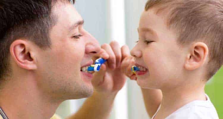 father & child brushing