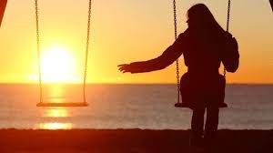 girl sitting alone on swings