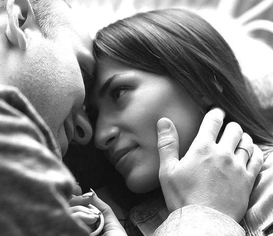 man holding girl's cheek