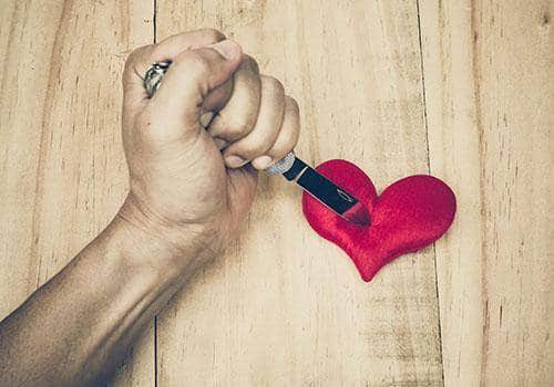 man stabbing heart