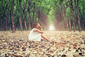 sad woman in forest