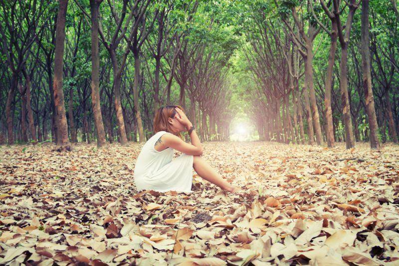 sad woman in forest
