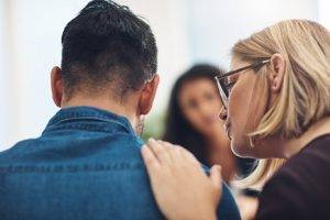 woman comforting man