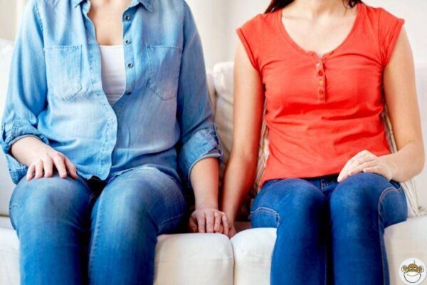 1064_happylesbiancouplesittingonsofa.jpg