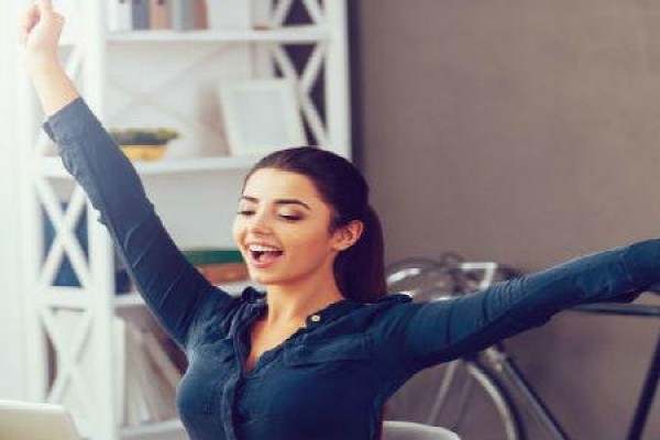 a happy woman at office arms stretched out