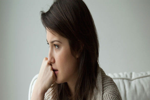 A sad young lady deep in thought