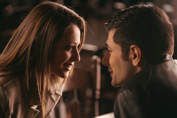 Couple at the bar staring at each other's eyes