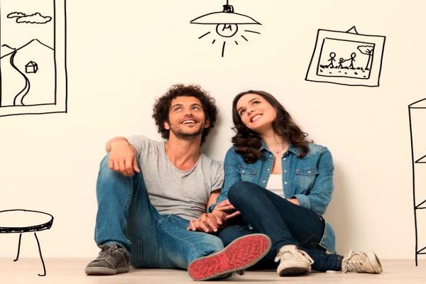 Happy couple sitting on floor