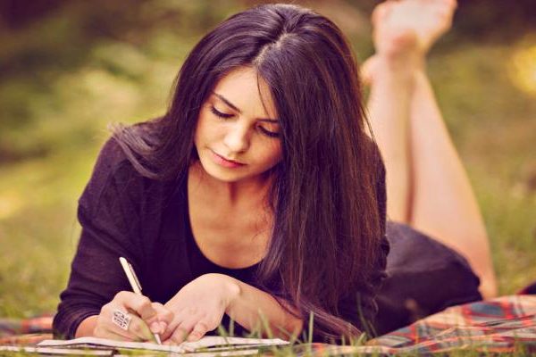 Lady, deep in thought, writing