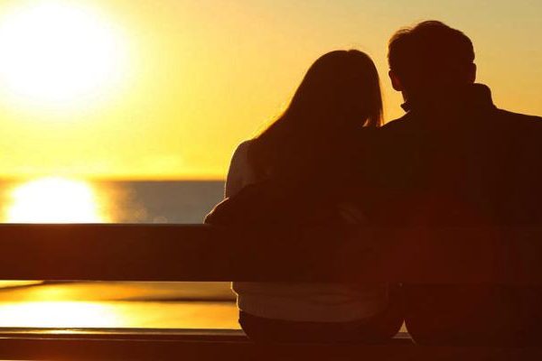 Silhouette of couple watching the sun set