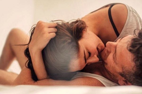 a couple cuddling in bed