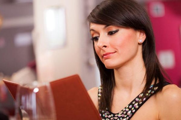 lady reading menu in restaurant