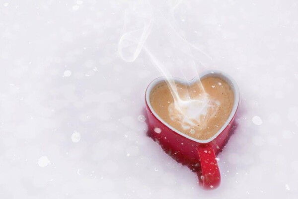 love shaped steaming cup of coffee