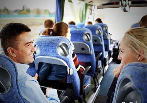 man and woman talking in a bus