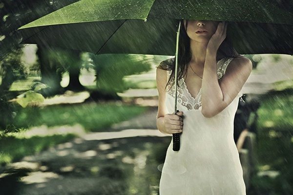 Sad woman with umbrella