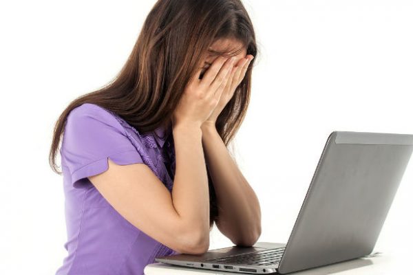 Sad girl in front of laptop