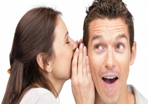 girl telling secret to boy