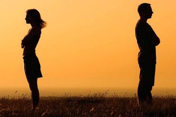 Silhouette of a man and woman facing away from each other