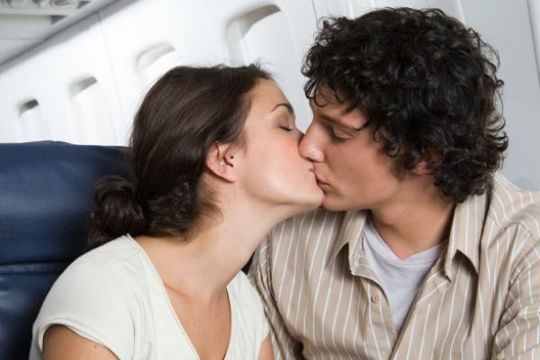 Couple kissing in airplane