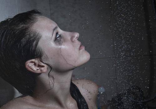 girl crying in the shower