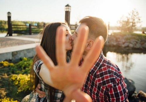 man and woman kissing in public