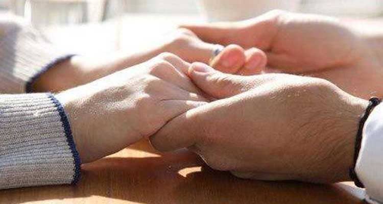 man holding hands of a woman