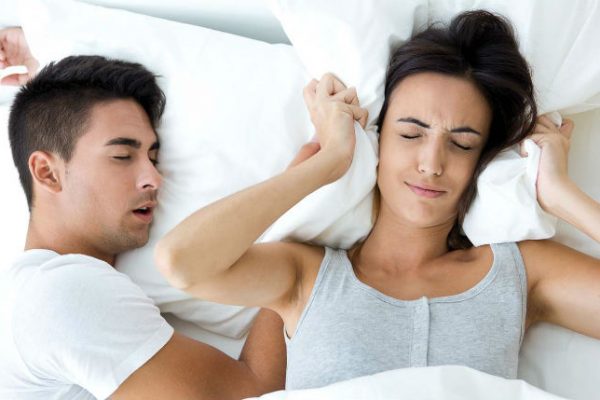 Man snoring woman unhappy
