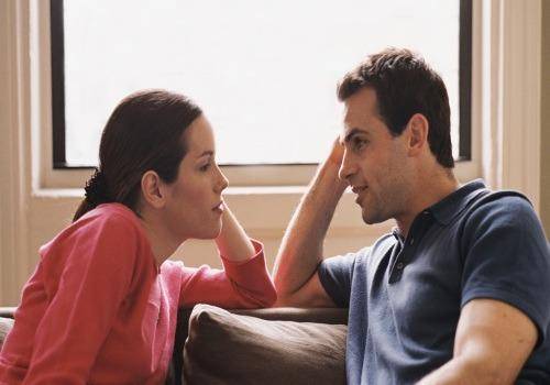 couple talking seriously in room