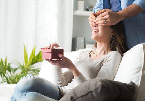 man giving woman surprise