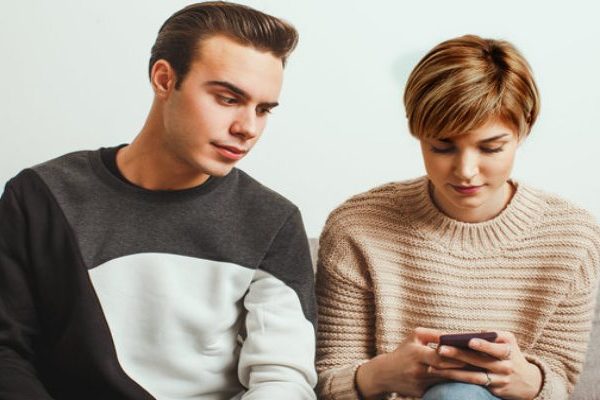 man seeing woman's phone