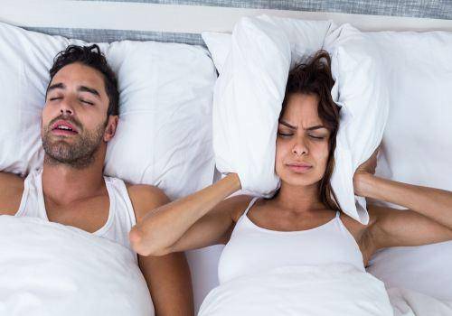 man snoring in bed