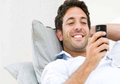 man texting with smile
