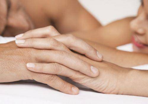 couple-holding-hands-in-bed