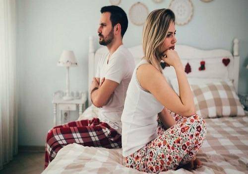 couple-sitting-on-bed-and-not-talking