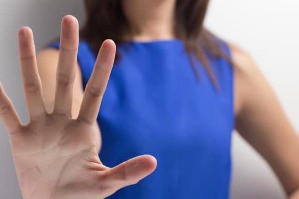 lady-showing-stop-sign-for-abuse