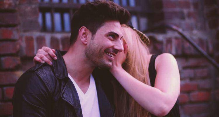 lady whispering in man's ear