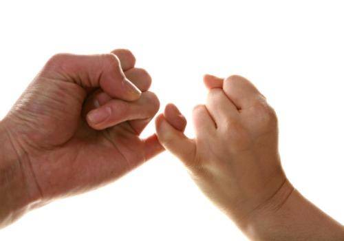 man and woman cross finger