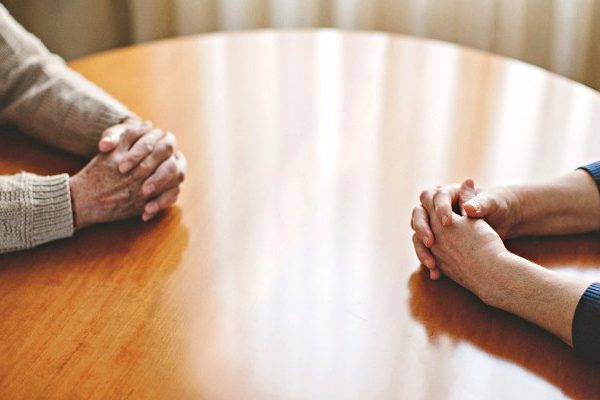 man and woman hands on the table