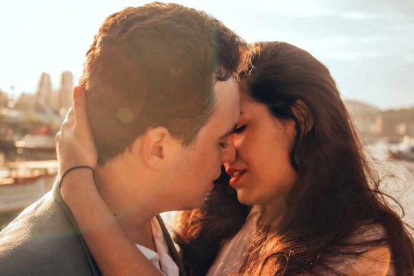 man and woman trying to kiss