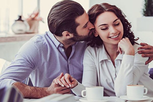 man kissing woman in the morning